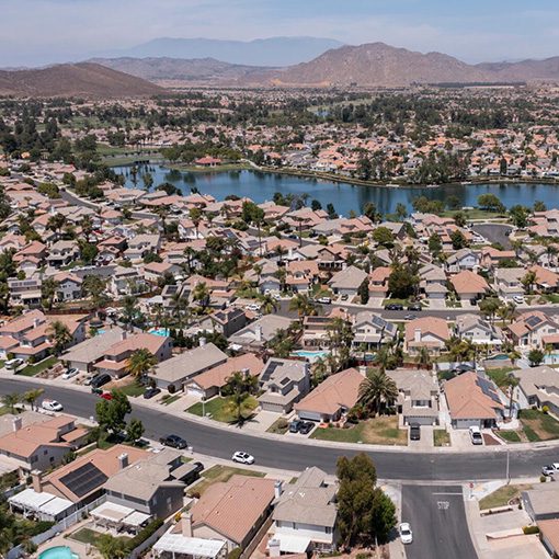 An aerial view of a large residential area with a river running through the center.